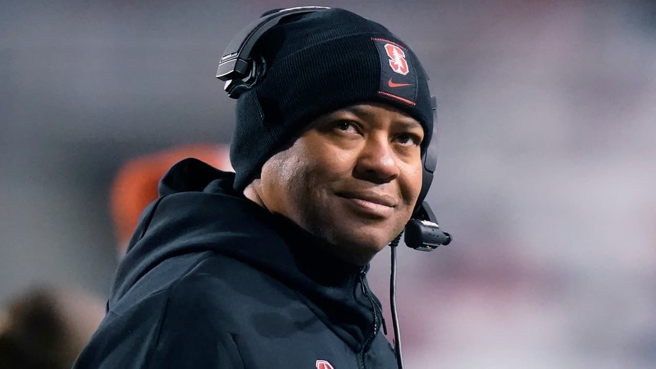 Former Stanford coach David Shaw wearing a black cap and hoodie