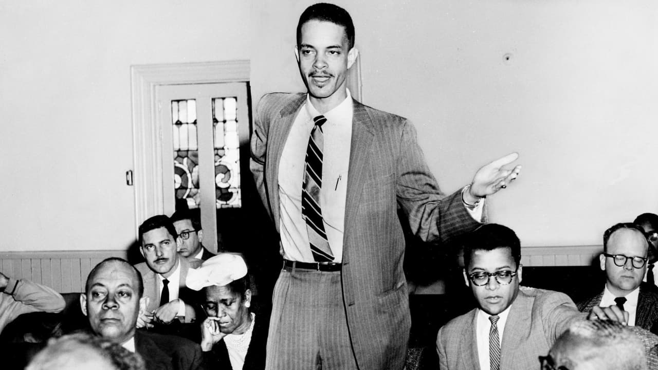 Rev. J. Metz Rollins speaks, with Ella Baker nearby, seated