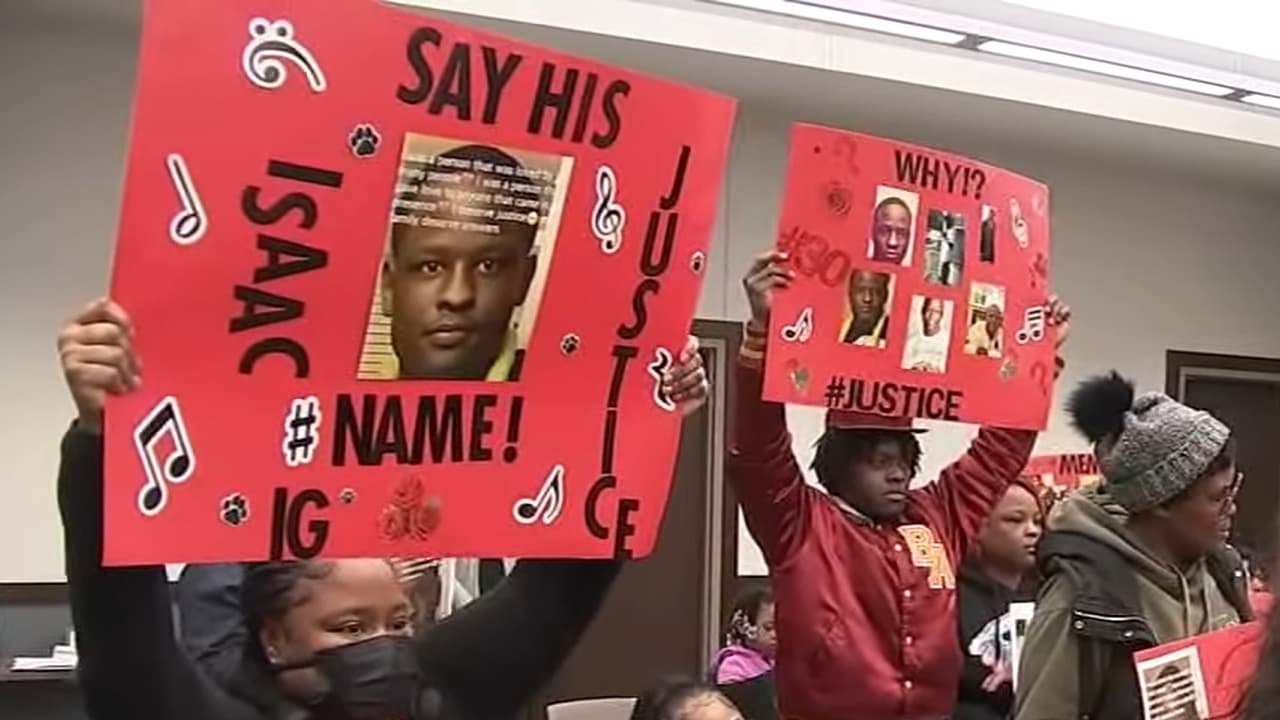 The family of Isaac Goodlow holds posters