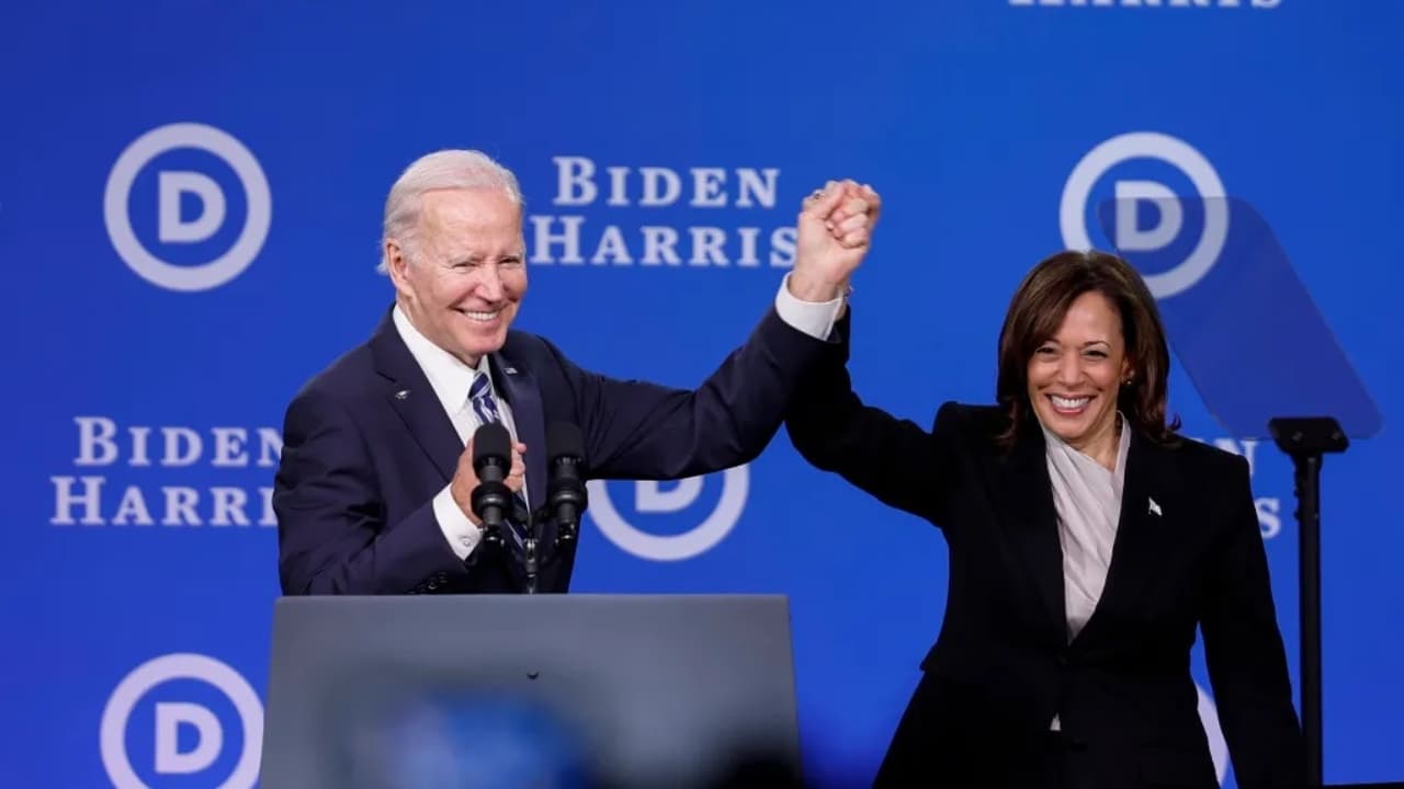 President Joe Biden raises the hand of Vice President Kamala Harris in victory