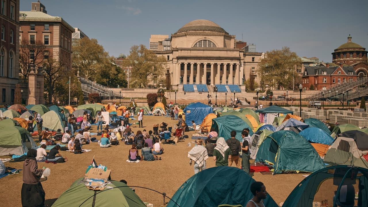 People listen to a speaker at a pro-Palestinian encampment at Columbia University