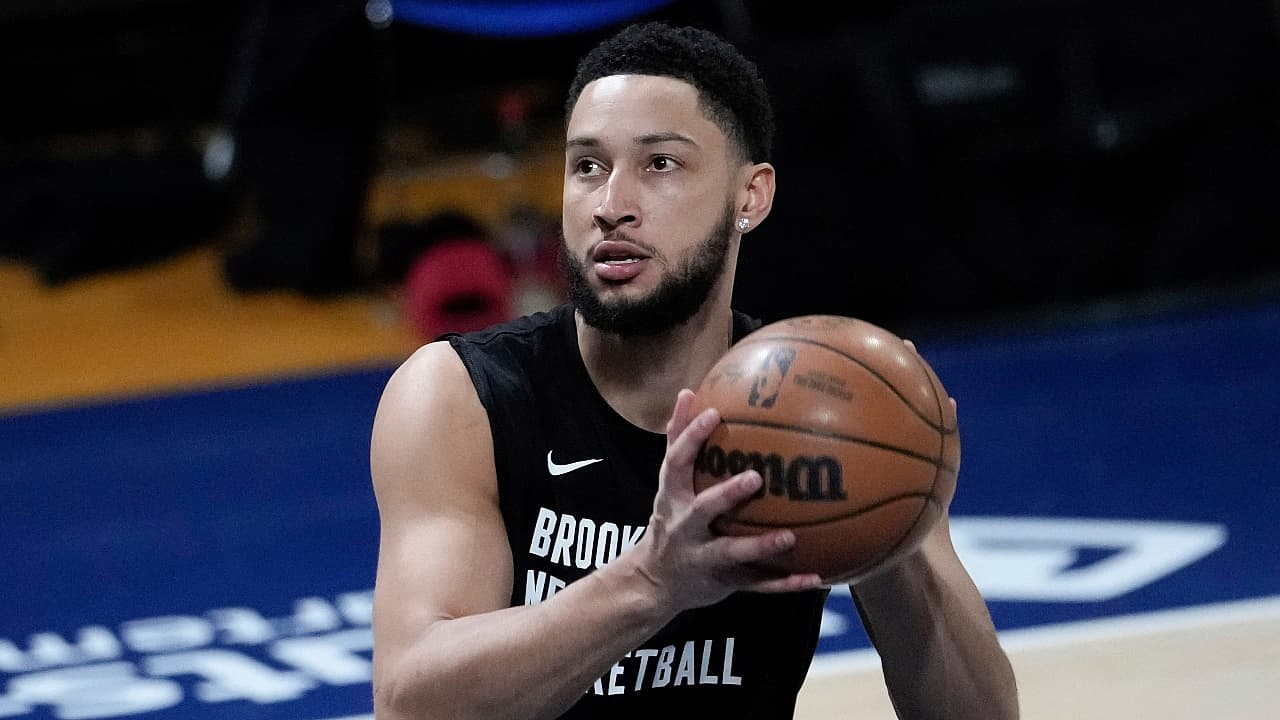 Brooklyn Nets guard Ben Simmons holding a basketball