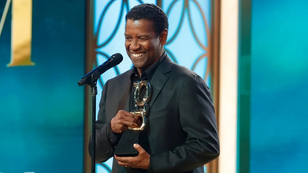 Actor Denzel Washington holding a theGrio award