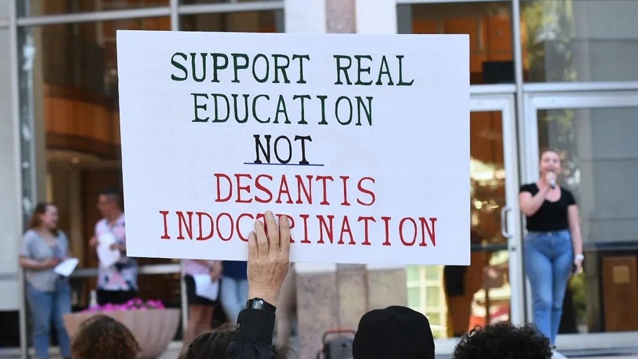A protest sign is shown at a “Walkout 2 Learn” rally
