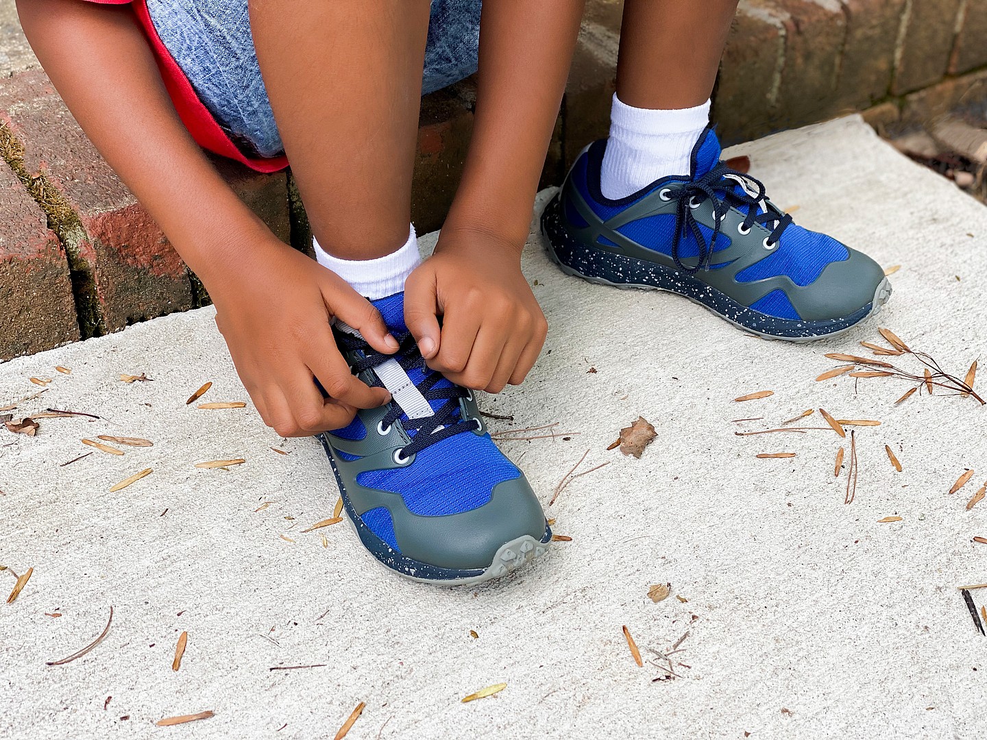 A person tying their shoes