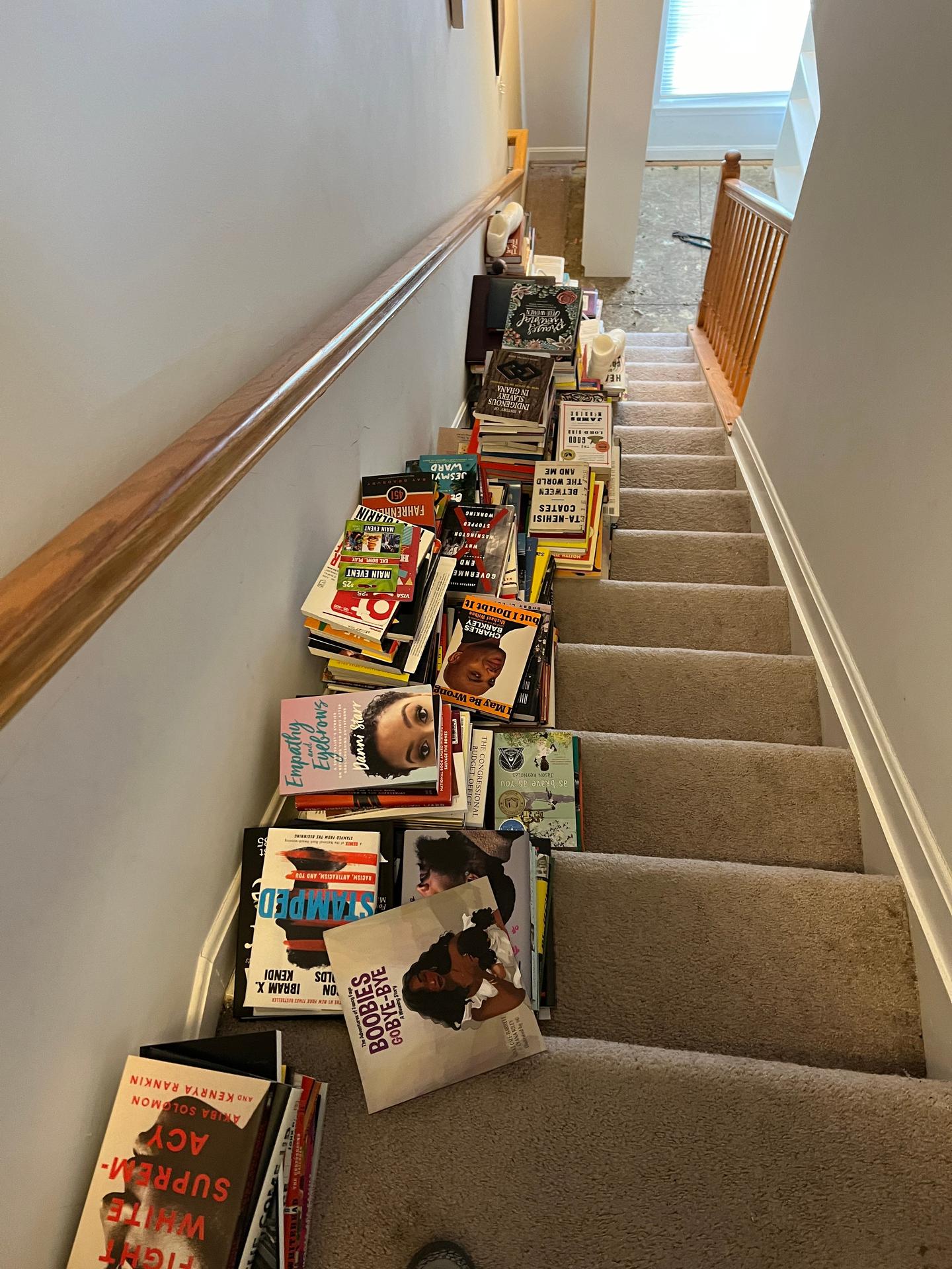 A staircase with stacks of books