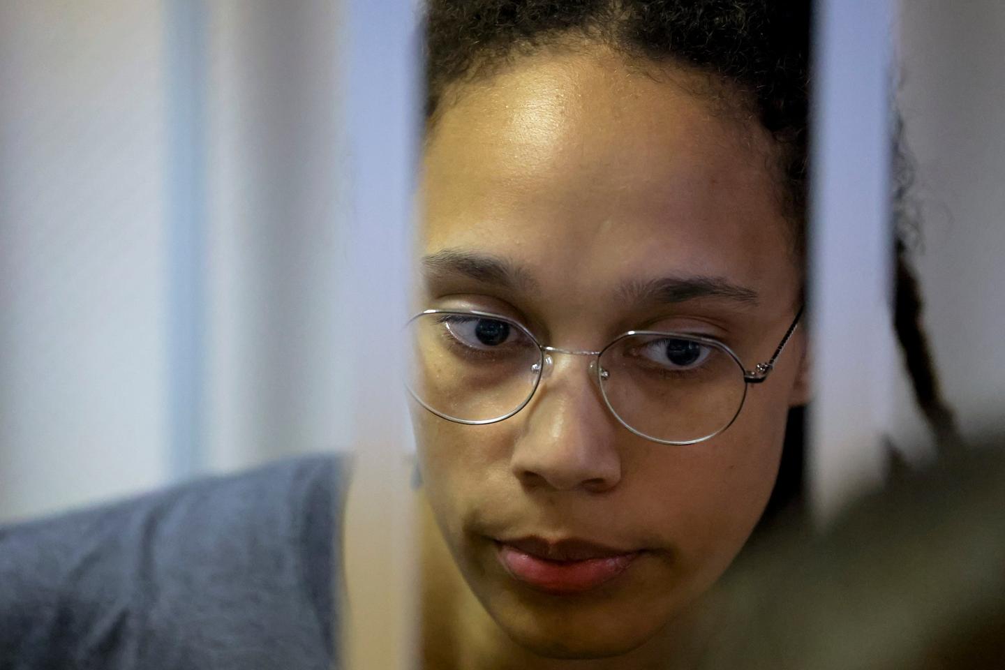 WNBA star and two-time Olympic gold medalist Brittney Griner stands in a cage in a courtroom in Russia