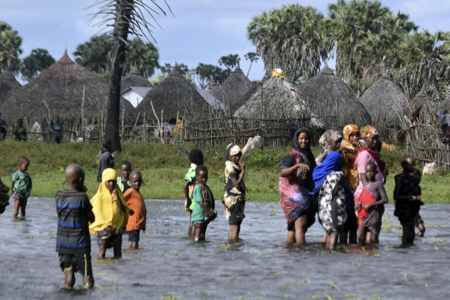 Residents are seen in the flooded village of Lumshi in Kenya