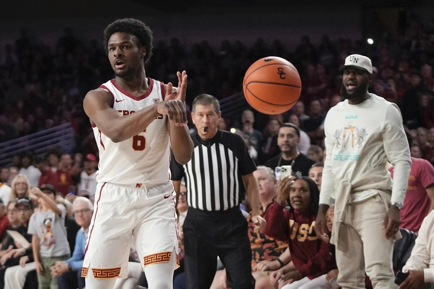 Southern California guard Bronny James passes the ball as his father LeBron James watches