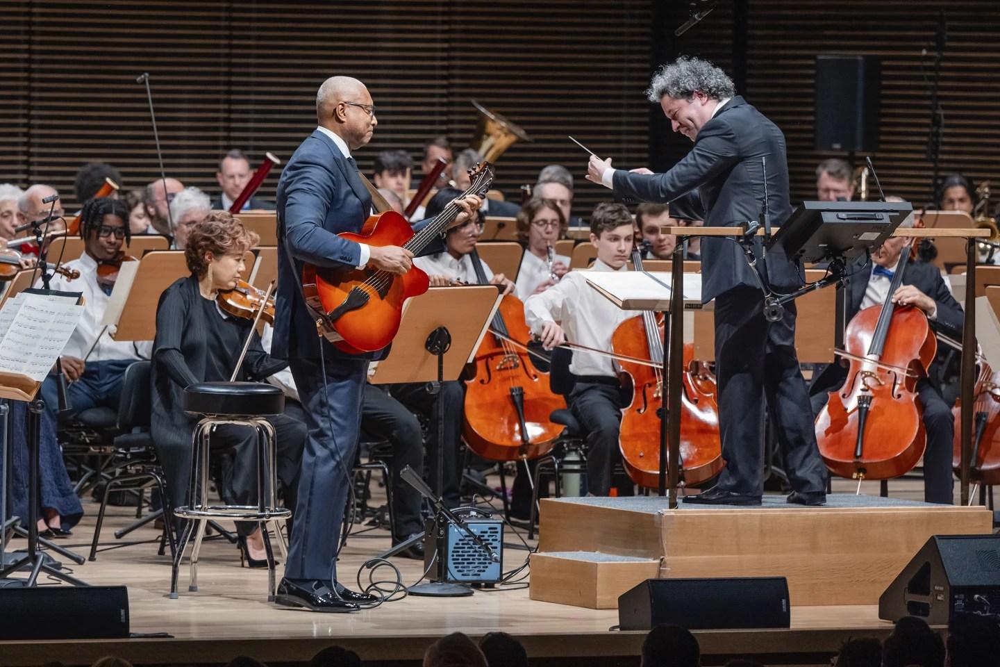 Former New York Yankees baseball player Bernie Williams with conductor Gustavo Dudamel