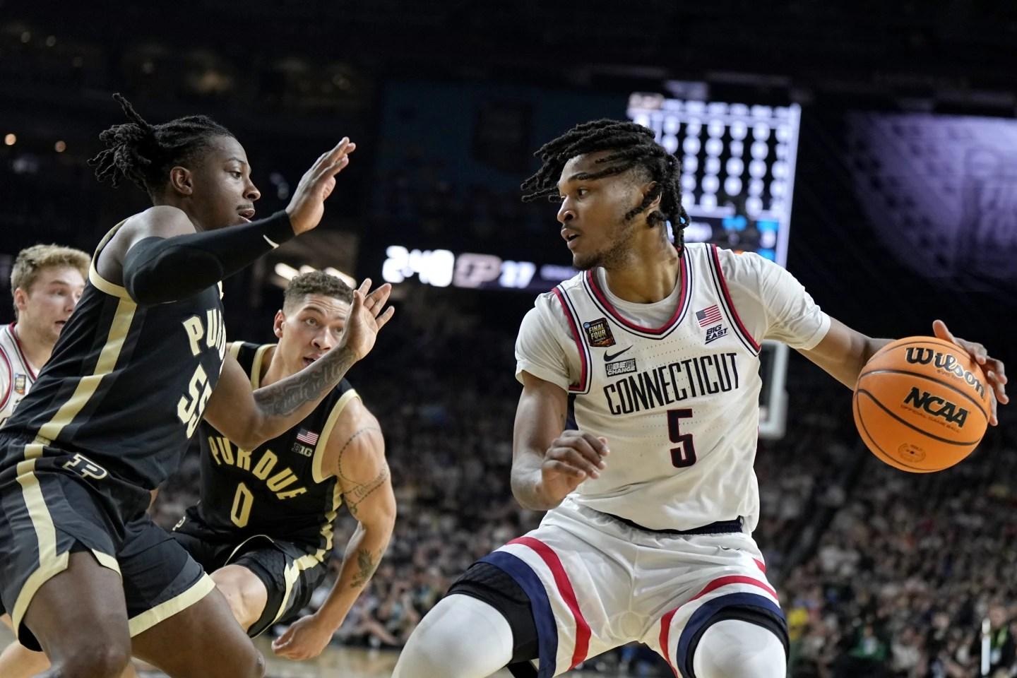 UConn guard Stephon Castle holding a basketball