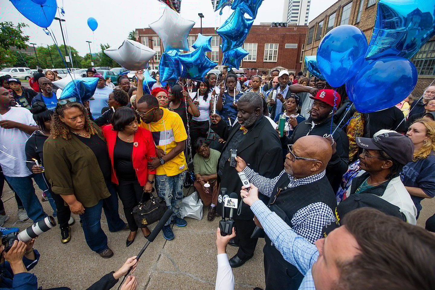 Guests gather and listen to community leaders speak during a vigil for Eric Logan Monday, June 17, 2019 on Washington Street in South Bend, Ind. Logan, 54, was killed in South Bend early Sunday after someone called police to report a suspicious person going through cars, according to the St. Joseph County prosecutor's office. (Michael Caterina/South Bend Tribune via AP)