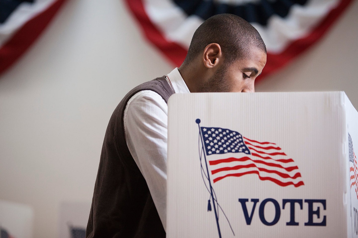 A man inside a voting booth