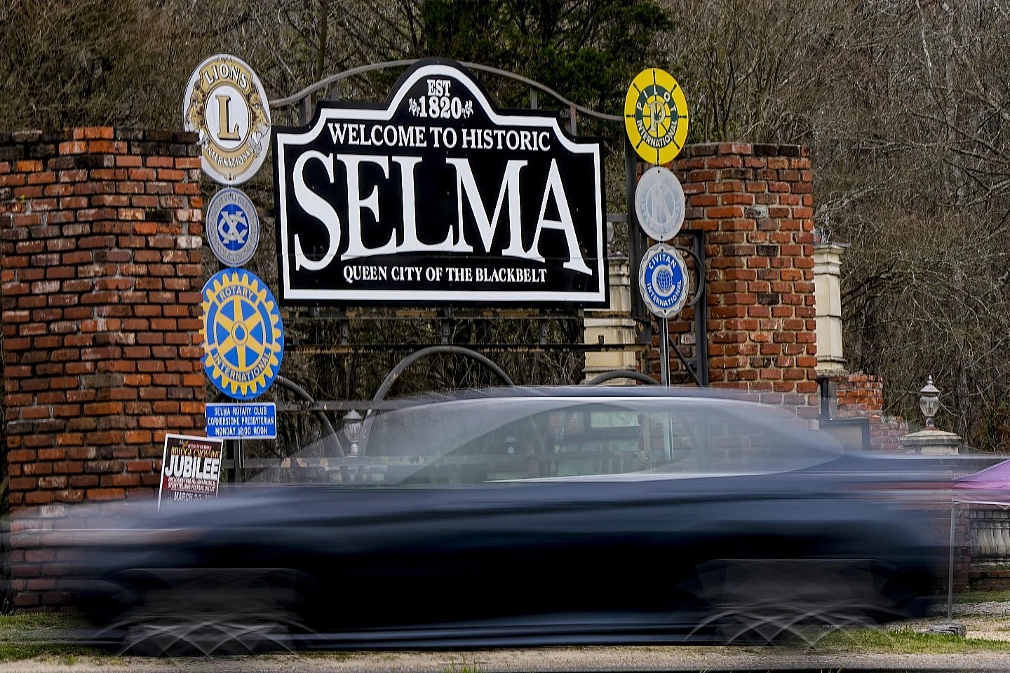 A vehicle passes by the town welcome sign in Selma, Alabama
