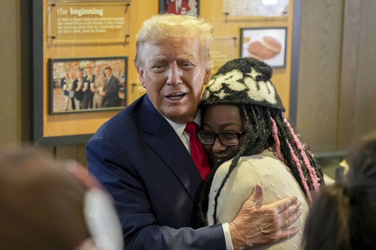 Former President Donald Trump hugs Michaelah Montgomery, a local conservative activist