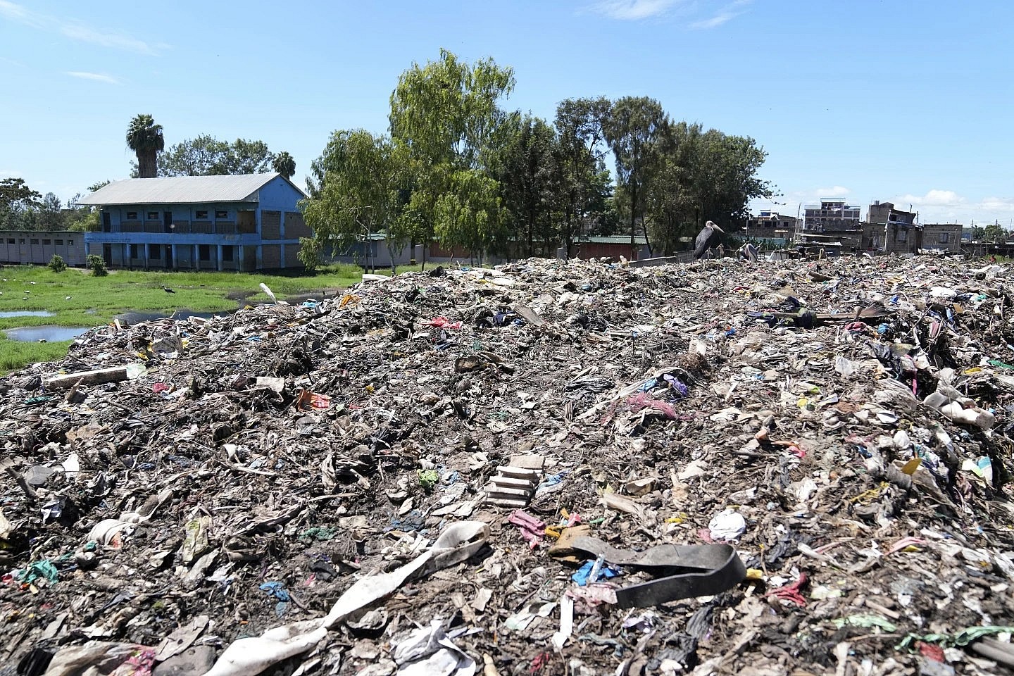 The Dandora Secondary school, near a mountain of garbage amidst smoke from burning trash