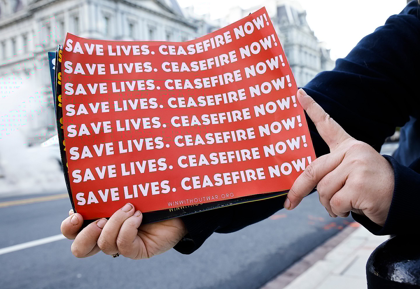 Posters reading "Save lives. Ceasefire now!"