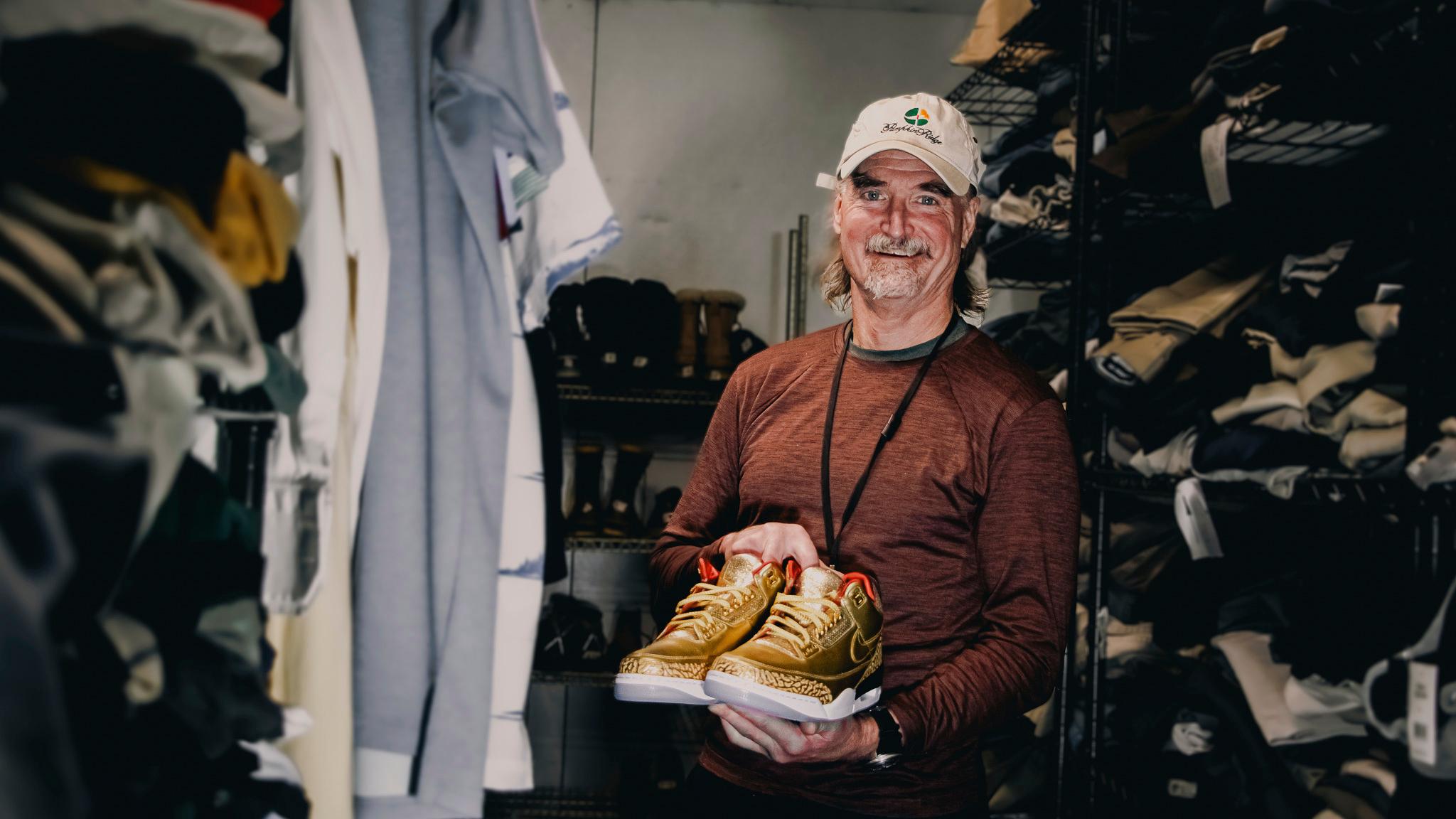 James Free with a pair of of gold Nike Air Jordan 3 sneakers
