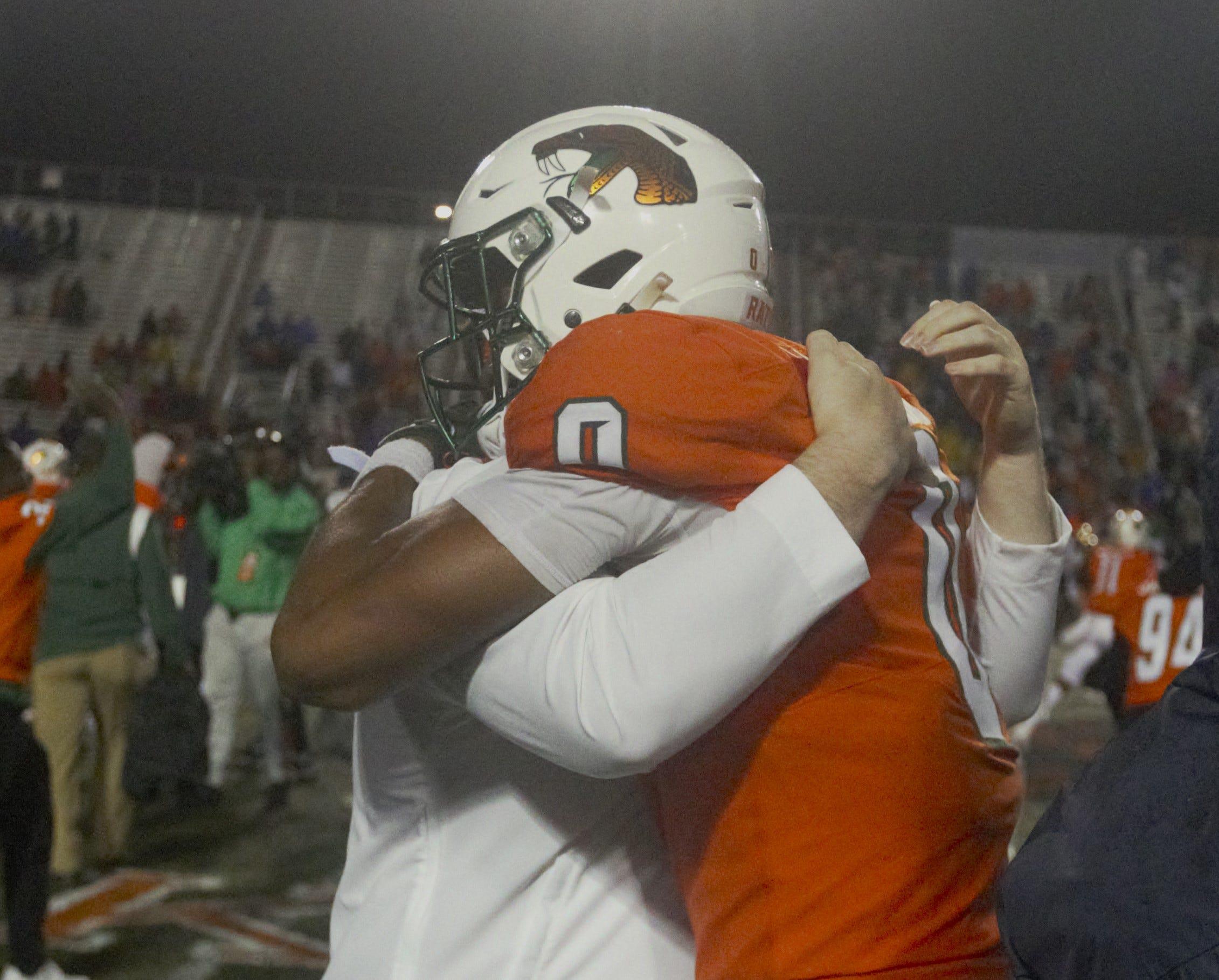A FAMU player gets a hug after his team overcame wet and soggy conditions to defeat Prairie View A&M