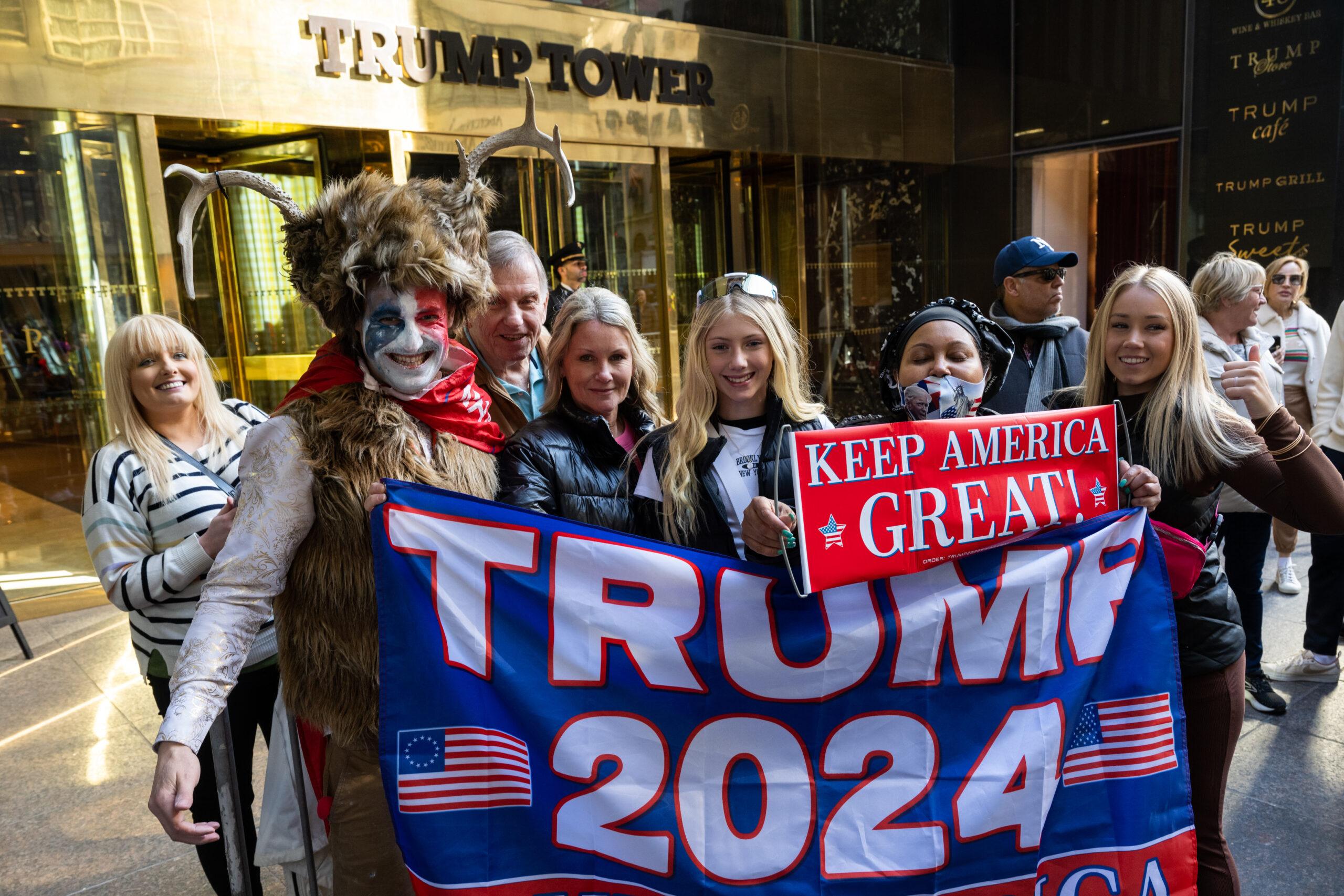 Supporters of former President Donald J. Trump pose with Steven Daniel Wolverton dressed like the Q-Anon Shaman