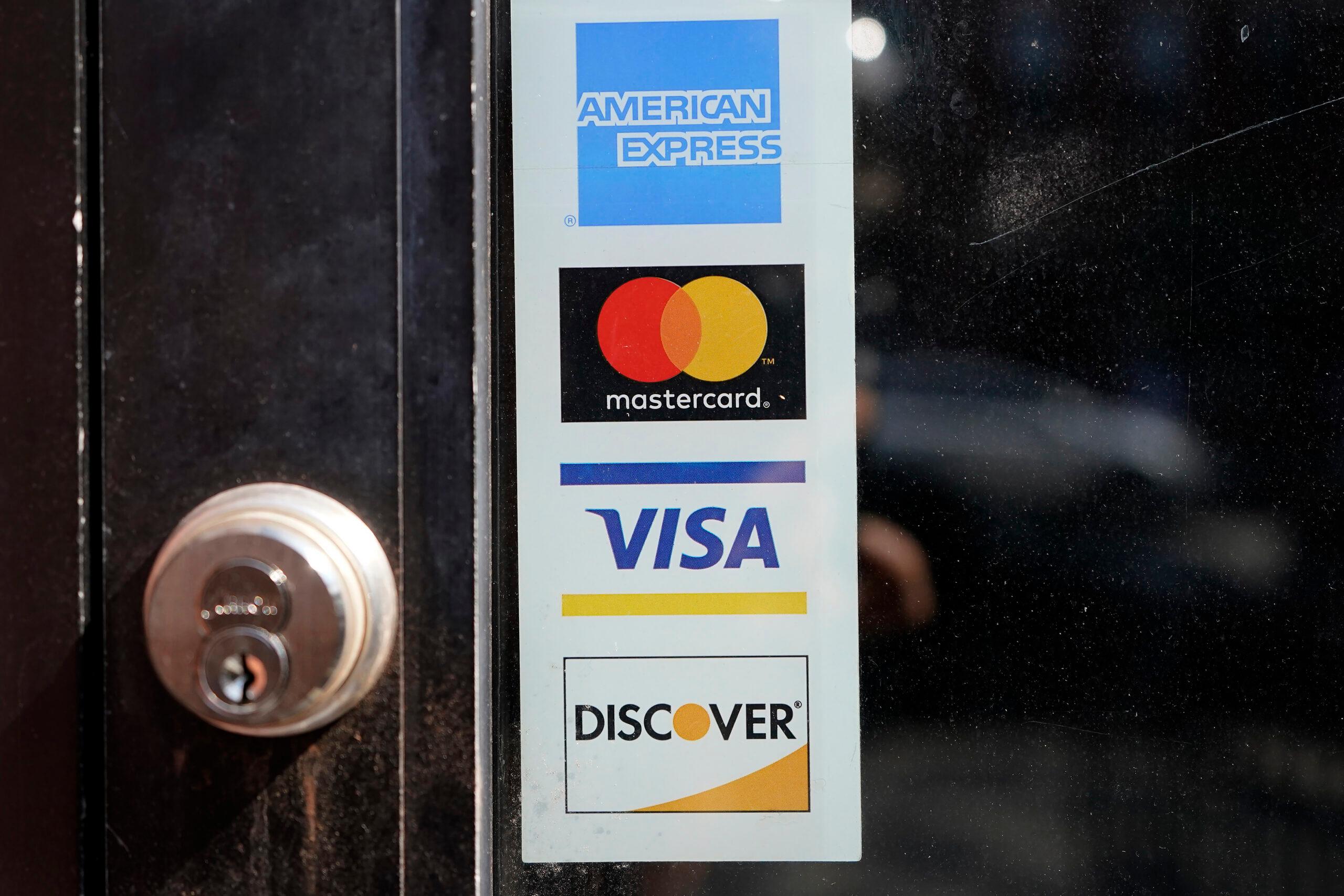 Credit card logos are displayed on a business’s door