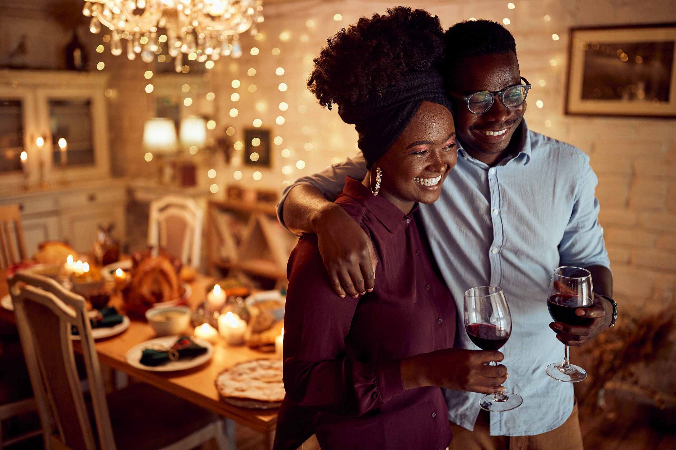 A smiling couple holding glasses of wine