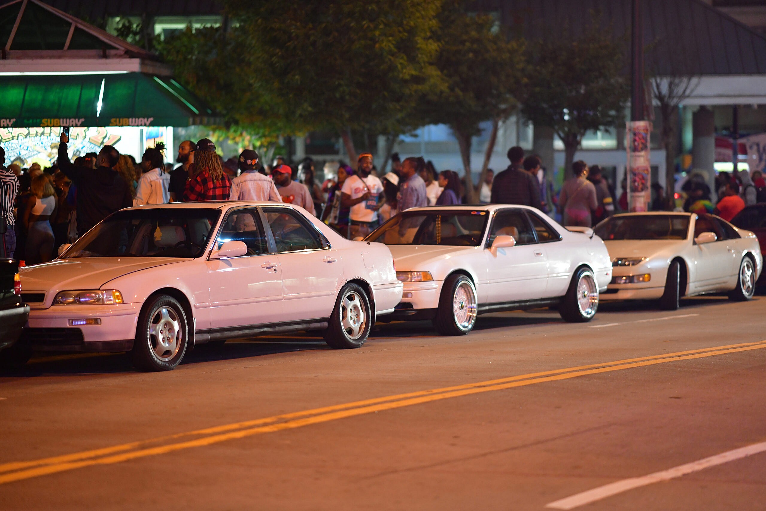 Crowded sidewalks near parked cars during Freaknik21