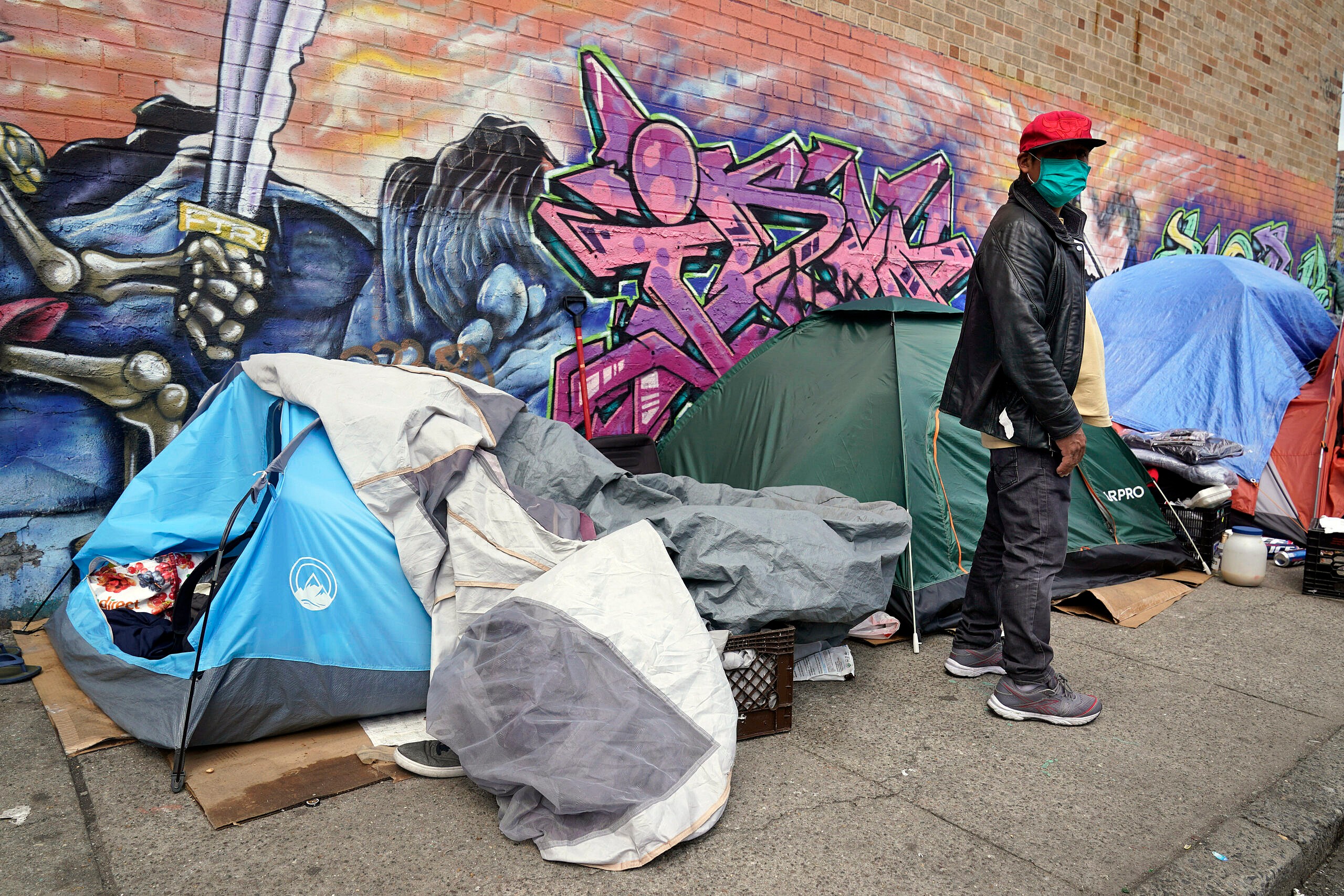 Sotero Cirilo stands near the tent where he sleeps