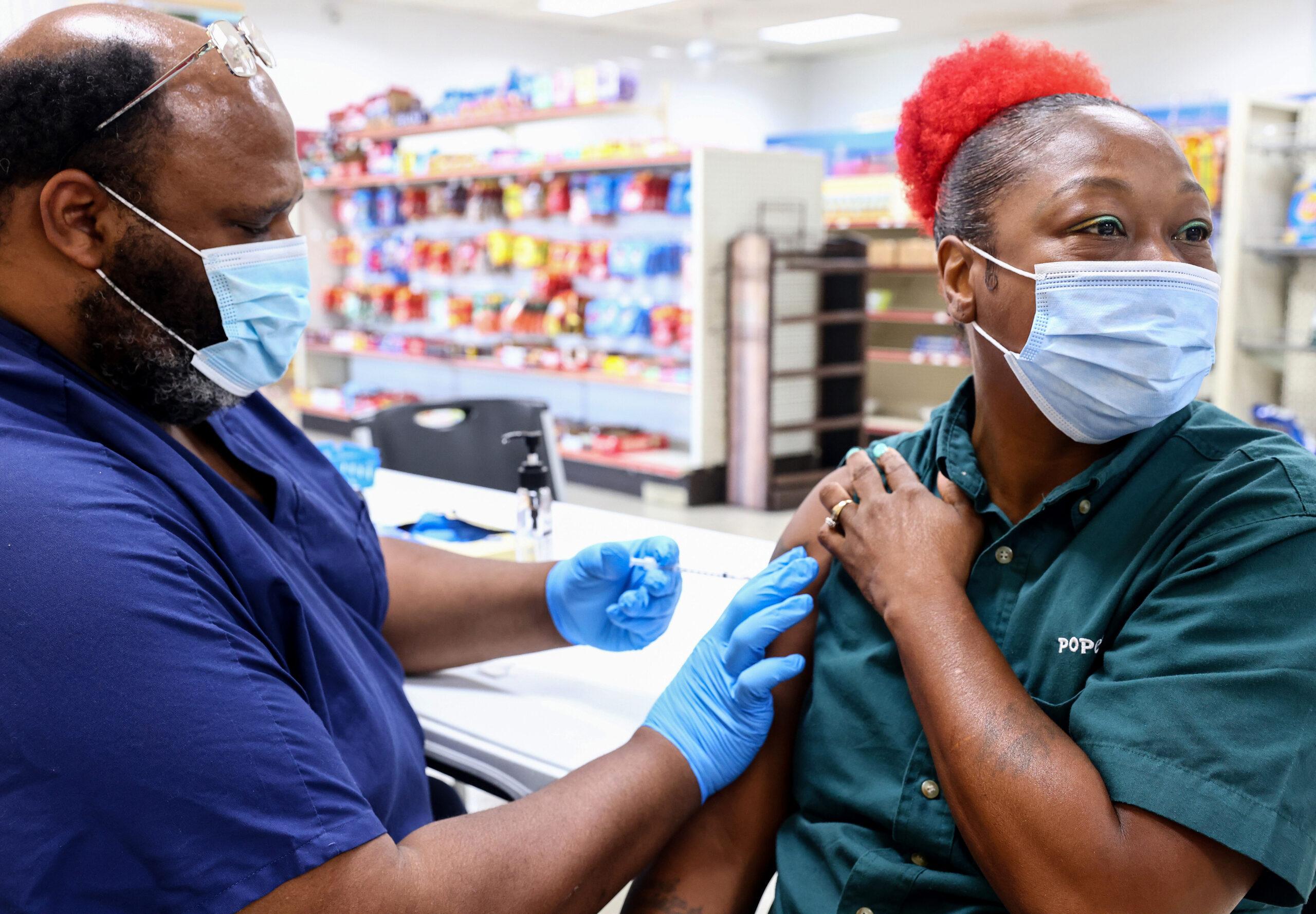 Licensed practical nurse Noah Johnson administers a COVID-19 vaccination dose as part of a vaccination campaign on Aug. 17, 2021, in Baton Rouge, Louisiana.