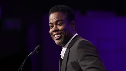 Comedian Chris Rock wearing a black jacket