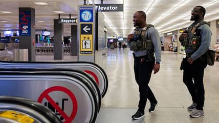 ICE agent, airport, Trump, theGrio.com