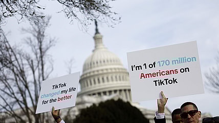 Participants hold signs in support of TikTok outside the U.S. Capitol Building