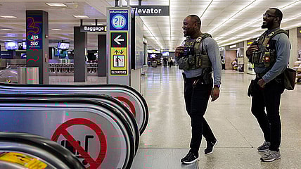 ICE agent, airport, Trump, theGrio.com