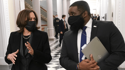 Vice President Kamala Harris walks with Vincent Evans