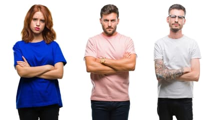 Three people standing with arms folded