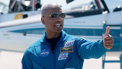 CAPE CANAVERAL, FLORIDA - MARCH 27: Artemis II crew member pilot Victor Glover gives a thumbs up after arriving at the Kennedy Space Center on March 27, 2026 in Cape Canaveral, Florida. The astronauts arrived to begin preparations for an April 1, 2026 launch for a 10-day mission, which will take them around the Moon and back to Earth. (Photo by Joe Raedle/Getty Images) theGrio.com