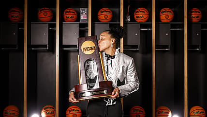Head coach Dawn Staley of the South Carolina Gamecocks kisses the NCAA trophy