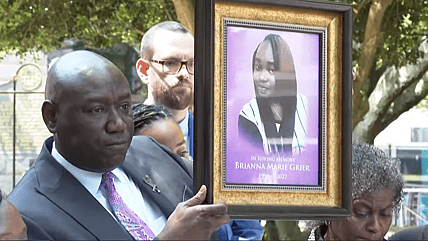 Ben Crump holding photo of Brianna Grier
