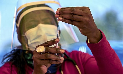 A health worker prepares a dose of the Pfizer coronavirus vaccine
