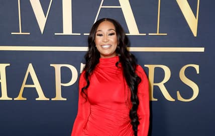 Melody Holt of OWN's "Love & Marriage: Huntsville" wears a long red dress and straight black hair to The Best Man event in Hollywood