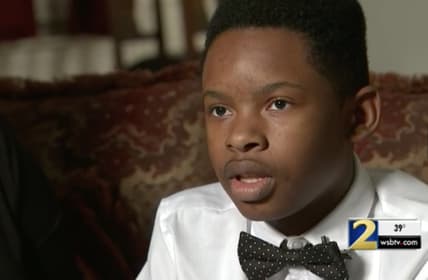 Christian Philon says he was suspended for using money he didn't know what fake to pay for school lunch. (WSB-TV)