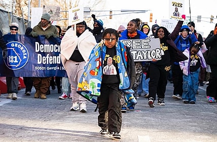 Danis-Taylor’s daughter Aby, seven, with family and marchers behind her in a rally that ended up at Atlanta’s ICE field office, on 1 February. Photograph: Courtesy Mildred Danis-Taylor