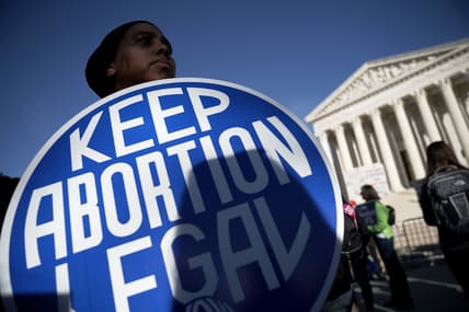 A pro-choice activist holds a sign
