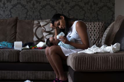 Mother feeding baby formula theGrio.com