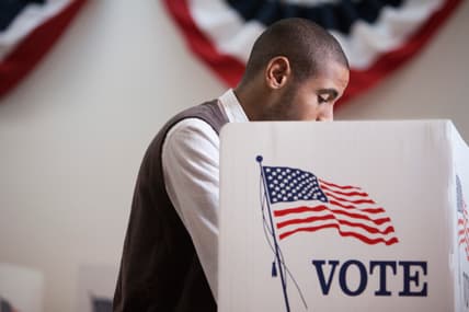 A man inside a voting booth
