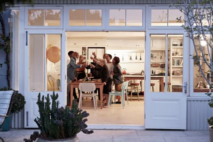 A family toasting around a kitchen table