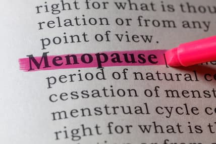 A dictionary page with the word "menopause" highlighted in pink