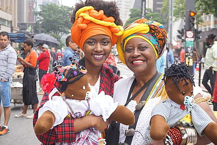 Black Consciousness Day Parade in São Paulo. She was just one-year-old when her grandmother brought her to her first parade. These days, dressed traditionally in headwraps and long skirts, she and her grandmother are seen at the annual event carryin thegrio.com