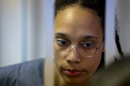 WNBA star and two-time Olympic gold medalist Brittney Griner stands in a cage in a courtroom in Russia