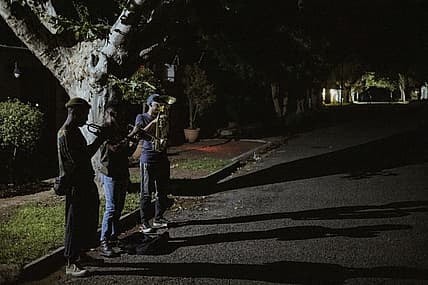 Members of The Middle of the Road Band Smiso, Franqo and Pro, play Christmas carols in Johannesburg